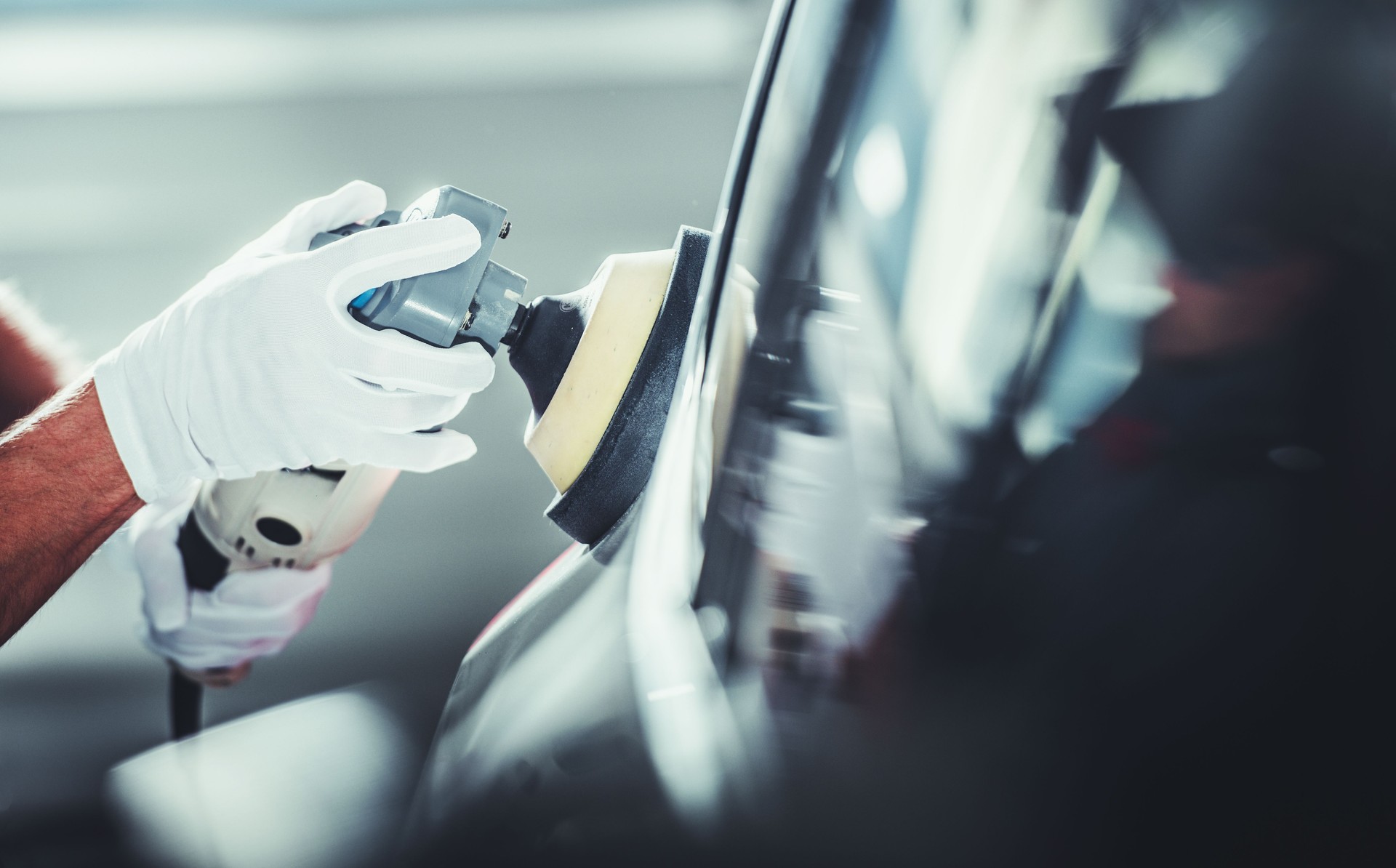 Automotive Worker Polishing Vehicle Body After Waxing